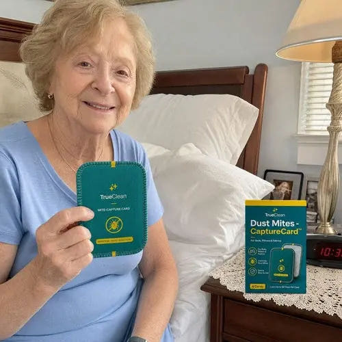 Supporting live-page photo of a woman holding a CaptureCard beside a bed
