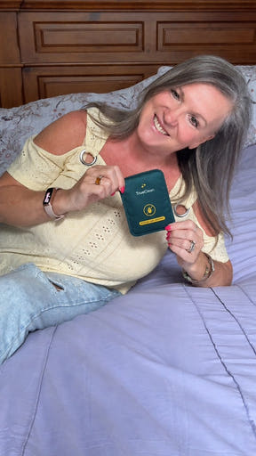 Creator holding a CaptureCard beside a bed