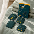 Four sealed CaptureCards lying flat beside the current box on folded linen