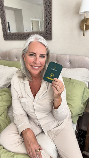 Creator holding a CaptureCard near pillows