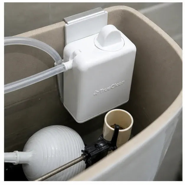 thumbnail — overhead shot of an open toilet tank with the Swoosh 'n Shine cartridge clipped to the overflow tube. Clean install, clearly visible.
